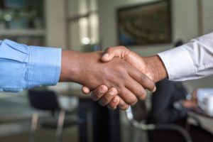 Two business people shaking hands Connecting