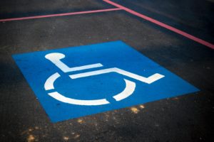 Image of bright blue handicap sign in parking lot. Department of veterans affairs.