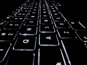 Black keyboard backlit by white LED. Department of Defense.