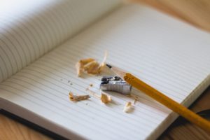 pencil pencil sharpener and shavings lying on a blank notebook