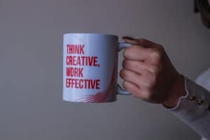Coffee mugs that says, "Think Creative, Work Effective." Marketing industry.