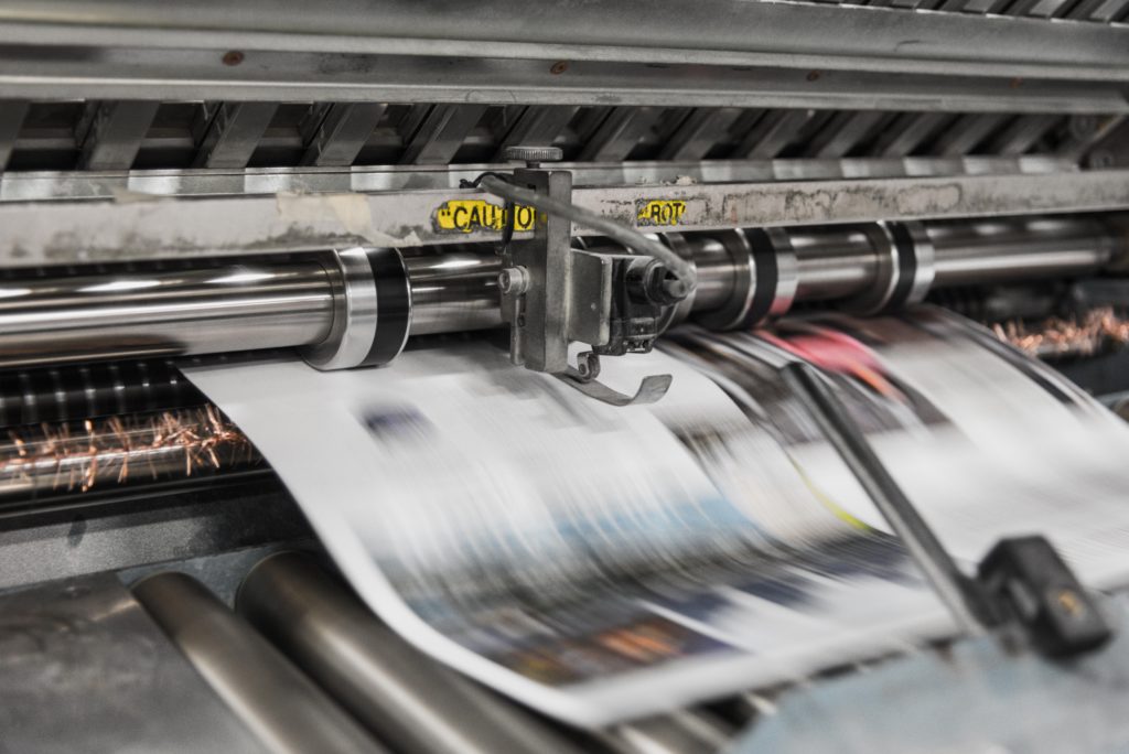 Printing press publishing newspaper. Printing services.