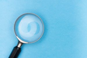 Magnifying Glass on blue background Proposal Myths