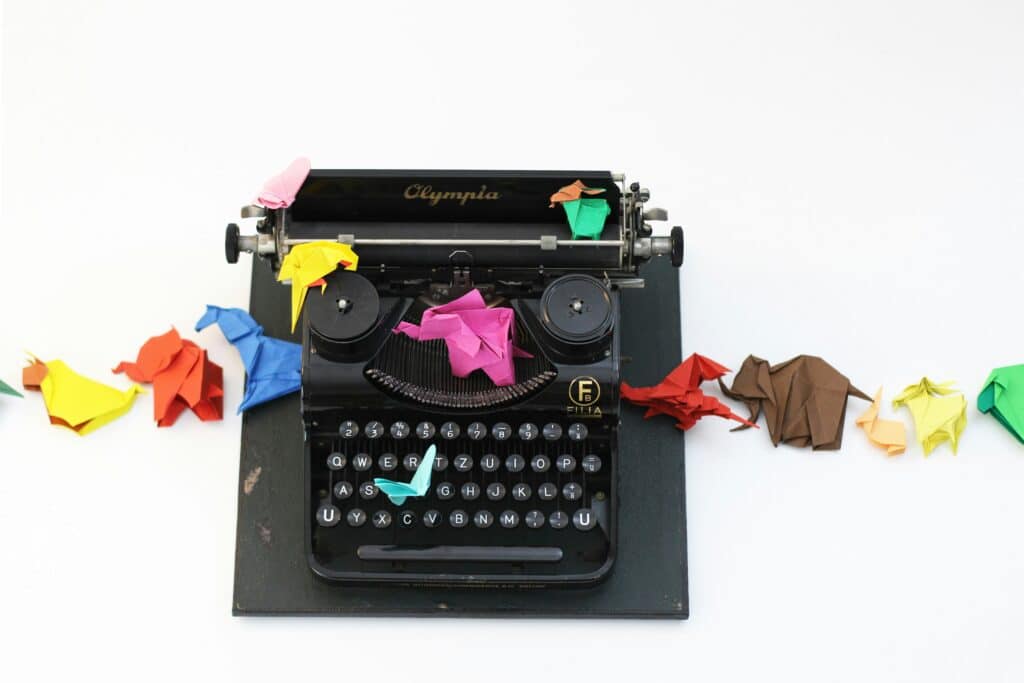 writers typewriter with colorful origami animals on top for some reason